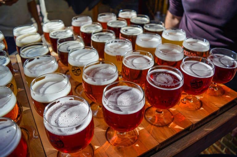 anonymous man tasting various types of beer in outdoor bar